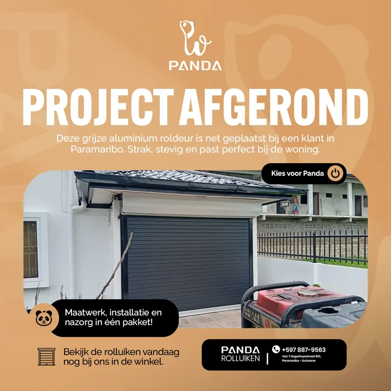 Post voor Panda Rolluiken: project afgerond, een grijze aluminium roldeur bij een woning in Paramaribo